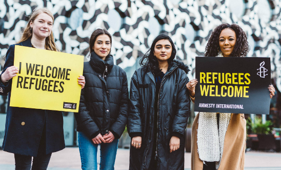 Amnesty activists stand together to welcome refugees Amnesty activists stand together to welcome refugees